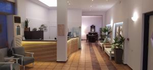 a hallway with a lobby with chairs and a desk at Hotel Kanelli Beach in Selianitika