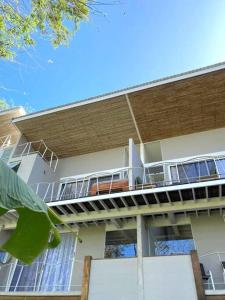 a building with a balcony on the side of it at BoHo Home in Gated Eco Residence marAmar - Top location in Santa Teresa Beach