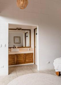 a bathroom with a sink and a mirror at BoHo Home in Gated Eco Residence marAmar - Top location in Santa Teresa Beach