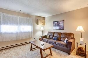 a living room with a leather couch and a table at Pierre Vacation Rental - 9 Mi to Oahe Dam! in Pierre