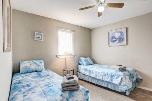 a bedroom with two beds and a ceiling fan at Pierre Vacation Rental with Grill and Fenced Yard in Pierre