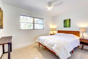 a bedroom with a bed and a desk and a window at Charming Sarasota Vacation Home Near Downtown in Sarasota