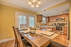 a kitchen with a wooden table with glasses of wine at Smyrna Townhome, Close to Truist Park! in Smyrna