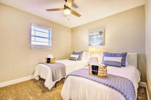 a bedroom with two beds and a ceiling fan at Spacious Columbia Vacation Rental Near Mizzou in Columbia