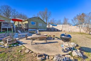 a backyard with a grill and a playground at Boho Mountain Home Escape, Walk to Marina! in Mountain Home