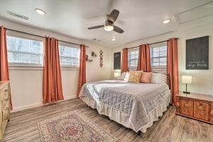 a bedroom with a bed with orange curtains at Boho Mountain Home Escape, Walk to Marina! in Mountain Home