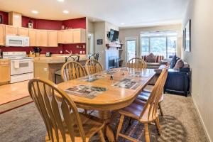 a kitchen and dining room with a wooden table and chairs at Kouls Retreat Condo 2 Mi to Lake Wenatchee in Leavenworth