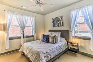 a bedroom with a bed and two windows at Dwtn Condo 4 Blocks to The Wilmington Riverwalk! in Wilmington