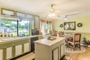 a kitchen with a sink and a table in a room at Downtown Cottonwood Home with Hot Tub and Patio! in Cottonwood