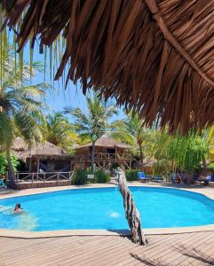 a dog in a swimming pool at a resort at Pousada BGK in Barra Grande