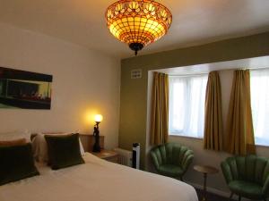 Ένα ή περισσότερα κρεβάτια σε δωμάτιο στο The Scala Hotel