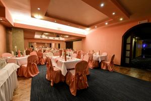 a banquet room with white tables and orange chairs at SPA Hotel Jawor in Jaworze +66 photos