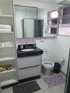 a bathroom with a sink and a toilet at De lucca home Studio in Florianópolis
