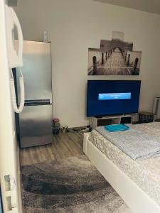 a living room with a refrigerator and a tv at Owen in Montargis