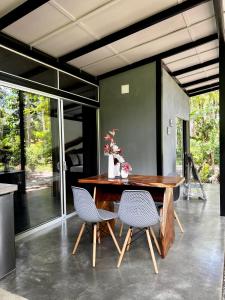 a dining room with a wooden table and chairs at Whispering Wisdom in Cahuita