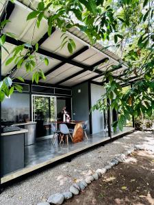 an open kitchen and dining room of a house at Whispering Wisdom in Cahuita
