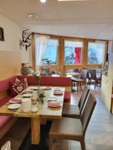a dining room with a table and chairs at Adler Hotel-Pension in Fulpmes