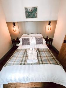 a large bed in a room with two tables at Luxury Apartment in the heart of Newcastle centre in Newcastle upon Tyne