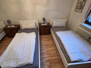 two beds in a small room with aermottermottermott at Apartment Colonia in Cologne