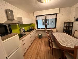 a kitchen with a table and a dining room at Apartment Colonia in Cologne