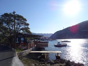 a river with a dock and boats in the water at Apartment Marlena in Mokošica