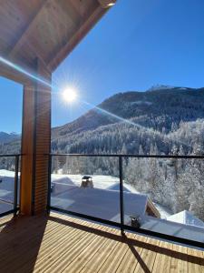 a balcony with a view of a snow covered mountain at LE DOUX MELEZE in Saint-Chaffrey