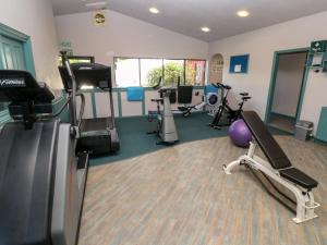 a gym with treadmills and exercise equipment in a room at Surfers Retreat in Falmouth