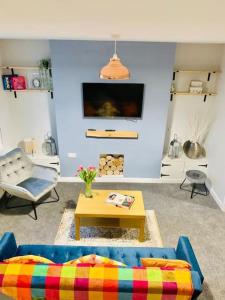 a living room with a couch and a table at Cosy home near Caerphilly 