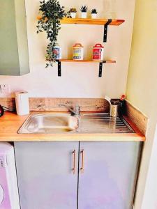 a kitchen with a sink and a counter top at Cosy home near Caerphilly 