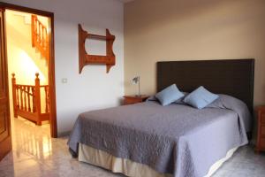 a bedroom with a large bed and a staircase at LA ORILLA BEACH HOUSE in Lajita