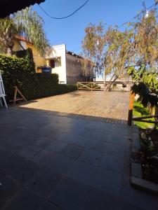 a patio with a table and a chair in a yard at Hotel Rio Acaraí in Camamu