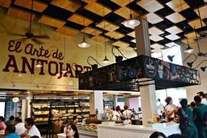 a crowd of people in a food court with a snowboard at Céntrico-A pie del mar y del Casco histórico+A/C in Santa Marta