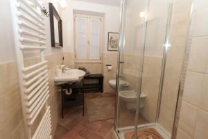 a bathroom with a shower and a sink and a toilet at Casa Pina in Menaggio