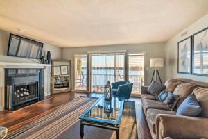 a living room with a couch and a fireplace at Sunset-View Resort Condo on Lake Hamilton! in Hot Springs