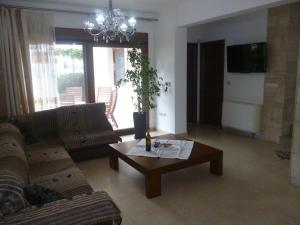 a living room with a couch and a coffee table at Villa Miramonti in Afantou