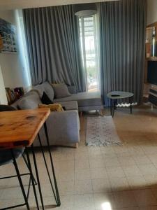 a living room with a couch and a table at הבית בואדי 