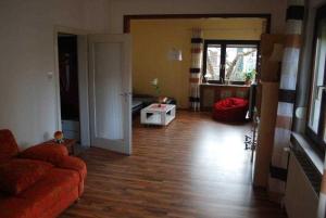 a living room with a couch and a hard wood floor at Ferienhaus Kaffenberger in Michelstadt