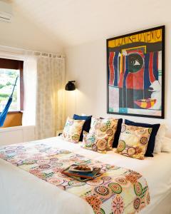 a bedroom with a bed with a blanket on it at Jubarte Hotel - Tawa Beach Club in Búzios