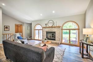 a living room with a couch and a fireplace at Family Home with Deck, Yard, Dock on Rock River in Janesville