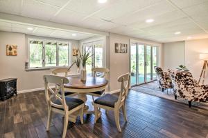 a dining room with a table and chairs at Family Home with Deck, Yard, Dock on Rock River in Janesville