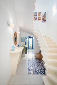 a staircase in a home with a blue and white tile floor at Chic, Stylish Traditional Townhouse with Terrace - St. Paul’s Bay in St Paul's Bay
