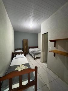 two beds in a room with two beds sidx sidx sidx sidx sidx at Pousada Rio Bonito in Bonito +38 photos