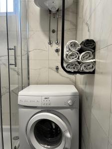 a laundry room with a washing machine and a washer at A&S in Ljubuški