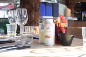 a table with glasses and a bottle of wine at SoBlue Hôtel in Antibes