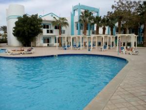 a large swimming pool in front of a building at A two-room chalet in the village of Lale Land, Mirage Bay, Ecopark in Hurghada
