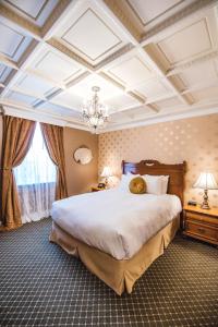 a bedroom with a large bed and a coffered ceiling at The Pollard Hotel in Red Lodge