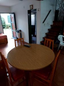 a wooden table and chairs in a room at Castillo Del Lago - Carlos Paz - D07 in Villa Carlos Paz