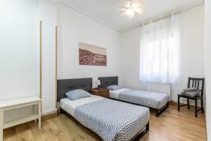 Postel nebo postele na pokoji v ubytování Apartamento junto al Guggenheim con parking gratuito
