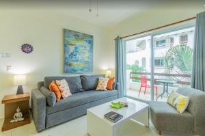 a living room with a couch and a table at Playa Kaan Condominiums- Unit 22 in Playa del Carmen