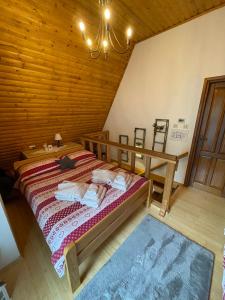 a bedroom with a bed in a wooden room at Chalet Calla in Mrkopalj
